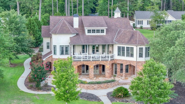 view of front of house featuring a front lawn and a patio area