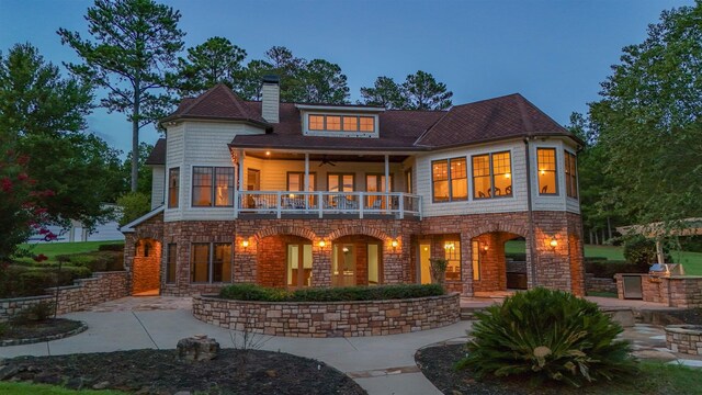 256 Jule Ingram Rd, Milledgeville, GA 31061 - back house at dusk with a balcony and a patio area