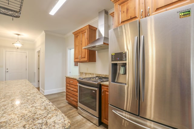 kitchen featuring ornamental molding, light stone counters, light hardwood / wood-style floors, stainless steel appliances, and wall chimney exhaust hood