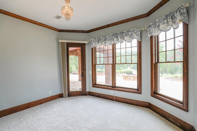 unfurnished room with crown molding and carpet