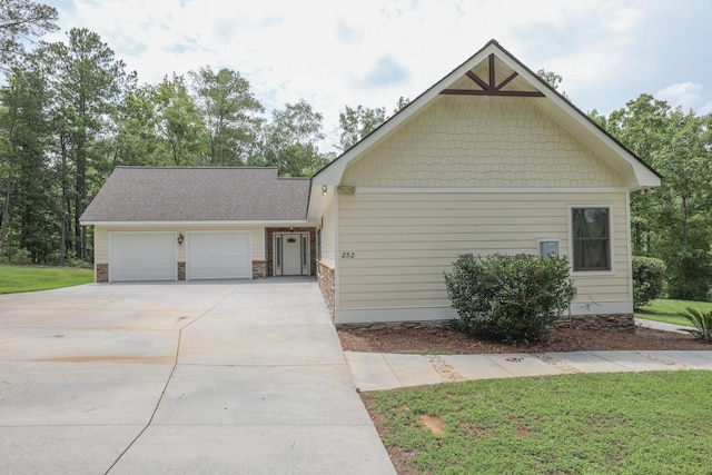 view of front facade with a garage and a front lawn