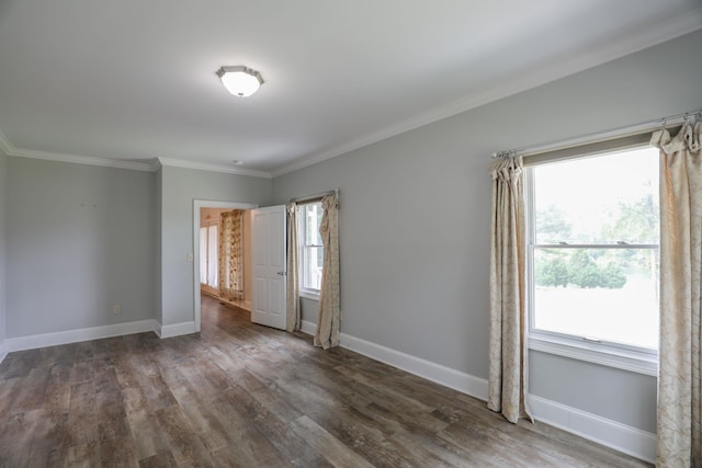 unfurnished room featuring crown molding, dark hardwood / wood-style floors, and a wealth of natural light