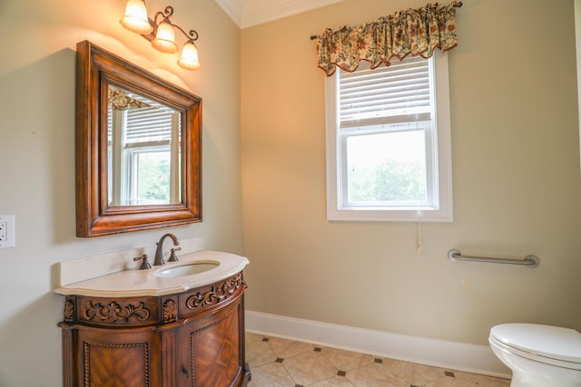 bathroom with tile patterned flooring, vanity, a wealth of natural light, and toilet