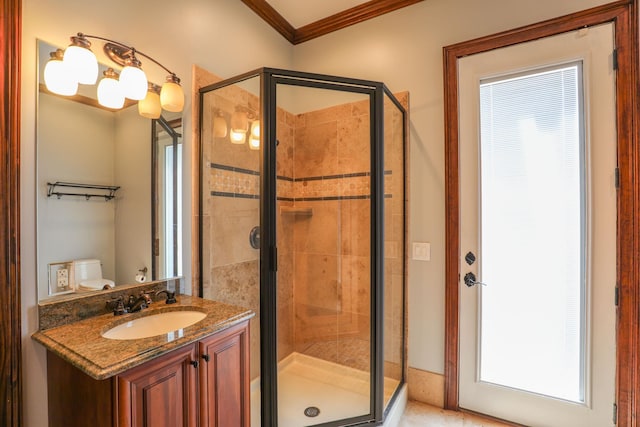 bathroom featuring crown molding, vanity, toilet, and an enclosed shower