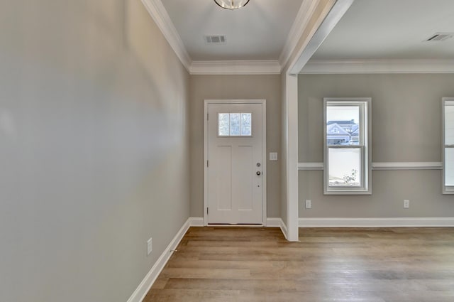 foyer entrance featuring ornamental molding and light wood-type flooring