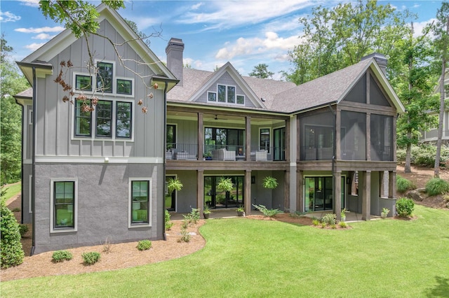 1070 Griffin Crk, Greensboro, GA 30642 - rear view of property featuring a yard, board and batten siding, a sunroom, a chimney, and a ceiling fan