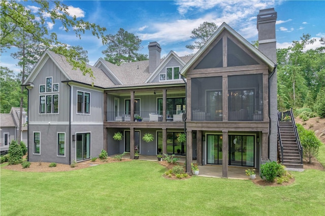 1070 Griffin Crk, Greensboro, GA 30642 - rear view of house featuring a chimney, stairway, a patio, a lawn, and board and batten siding