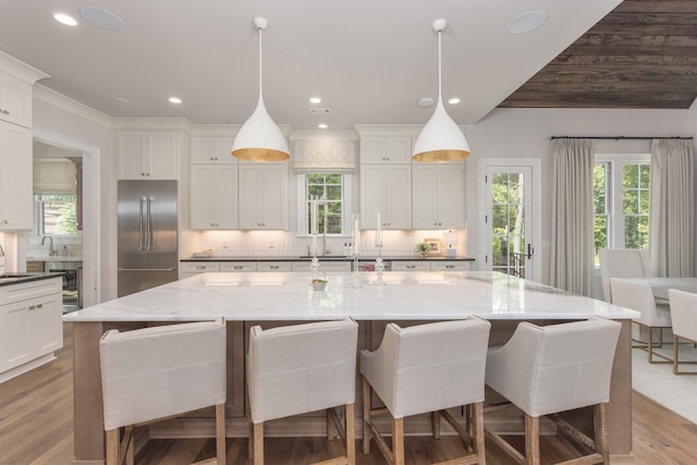 1070 Griffin Crk, Greensboro, GA 30642 - kitchen with built in refrigerator, backsplash, plenty of natural light, and recessed lighting