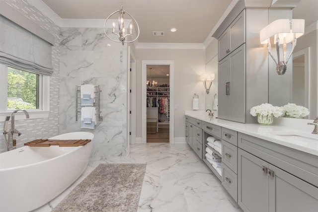 1070 Griffin Crk, Greensboro, GA 30642 - full bath featuring a chandelier, double vanity, a freestanding tub, a spacious closet, and crown molding
