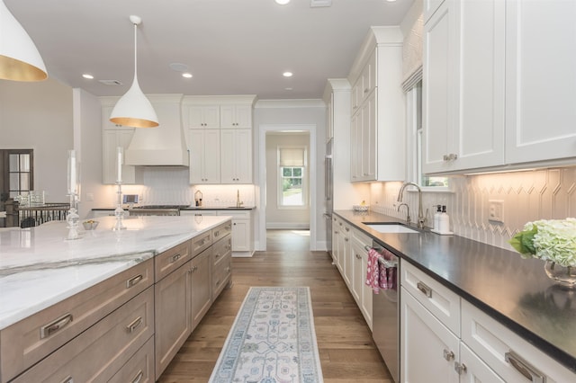 1070 Griffin Crk, Greensboro, GA 30642 - kitchen with appliances with stainless steel finishes, custom range hood, white cabinets, decorative backsplash, and hanging light fixtures