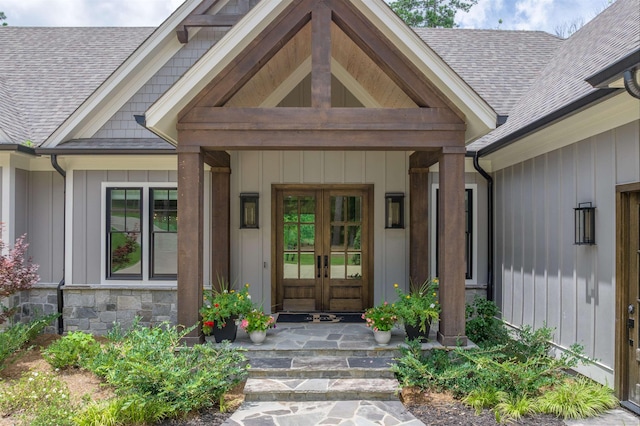 1070 Griffin Crk, Greensboro, GA 30642 - property entrance featuring a shingled roof, board and batten siding, french doors, and stone siding