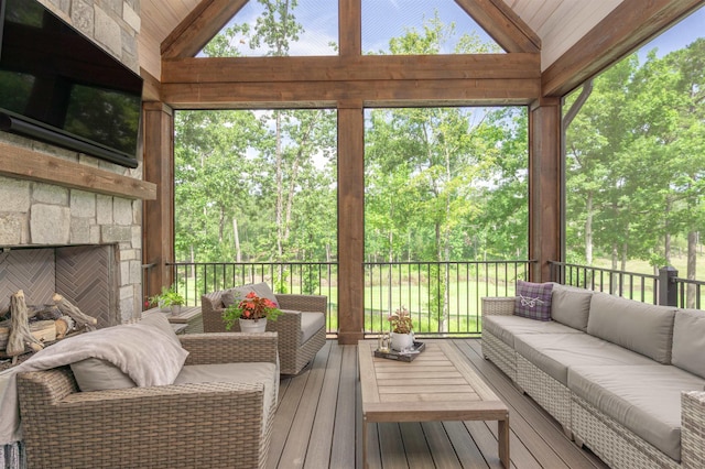 1070 Griffin Crk, Greensboro, GA 30642 - sunroom with an outdoor living space with a fireplace, vaulted ceiling, and view of scattered trees
