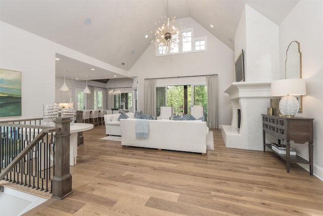 1070 Griffin Crk, Greensboro, GA 30642 - living area featuring a chandelier, high vaulted ceiling, light wood finished floors, healthy amount of natural light, and recessed lighting