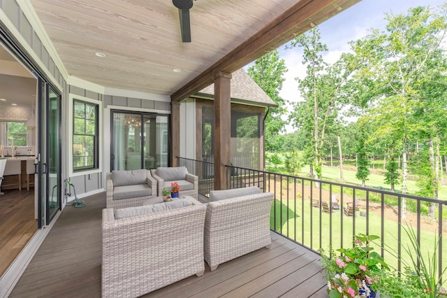 1070 Griffin Crk, Greensboro, GA 30642 - wooden deck with outdoor lounge area, a lawn, a ceiling fan, and view of scattered trees