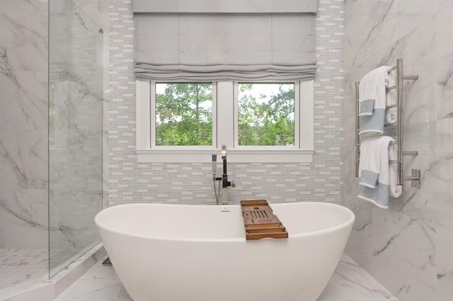 1070 Griffin Crk, Greensboro, GA 30642 - bathroom featuring marble tiled floors, tile walls, a freestanding tub, and a marble finish shower