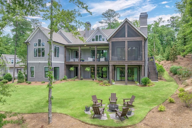 1070 Griffin Crk, Greensboro, GA 30642 - back of house with an outdoor fire pit, a chimney, stairs, and a lawn