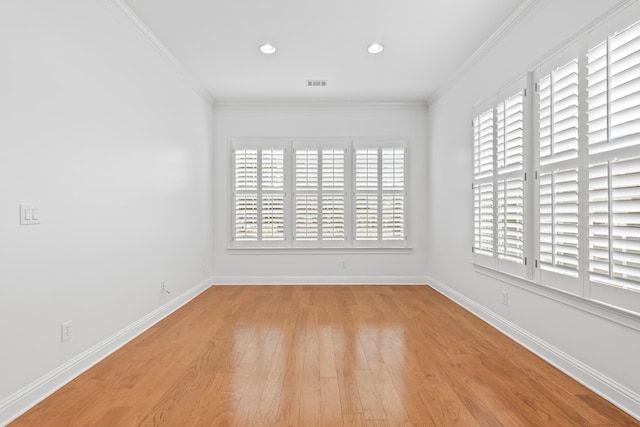 unfurnished room with crown molding and light wood-type flooring