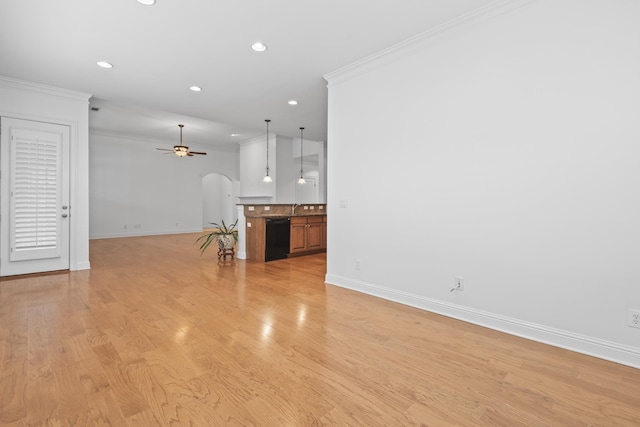 unfurnished living room featuring sink, ornamental molding, light hardwood / wood-style floors, and ceiling fan