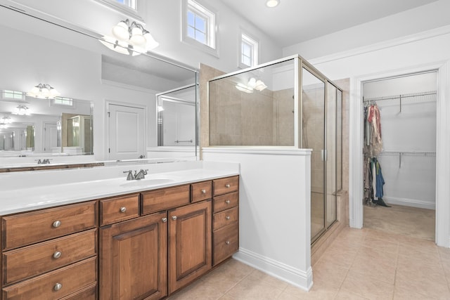 bathroom featuring vanity, tile patterned flooring, and a shower with door