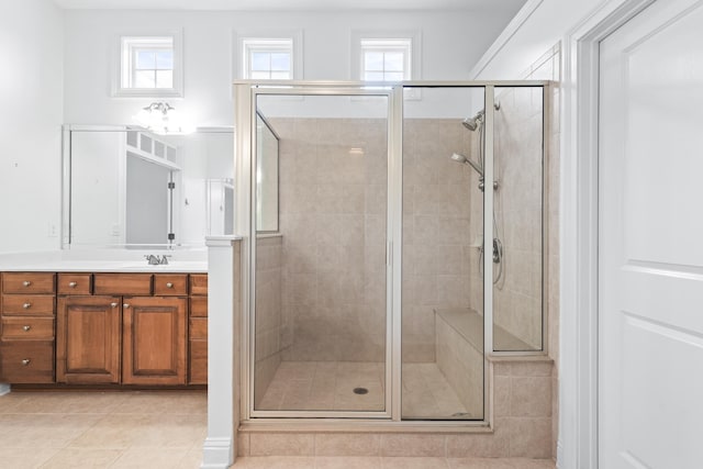 bathroom featuring vanity, tile patterned floors, and a shower with door