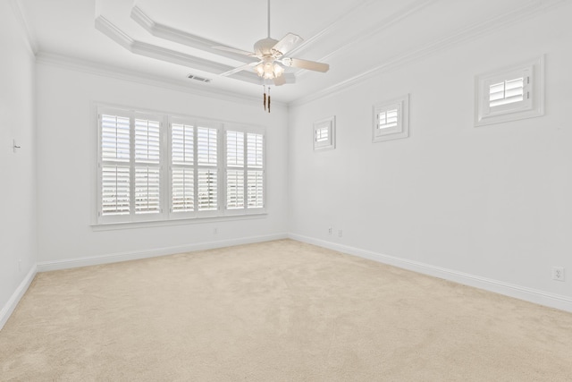 carpeted empty room featuring ornamental molding, a raised ceiling, and ceiling fan