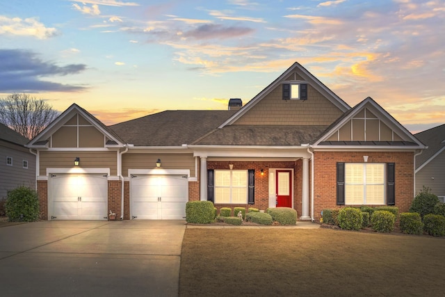 craftsman-style home featuring a garage and a yard