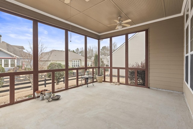 unfurnished sunroom featuring ceiling fan