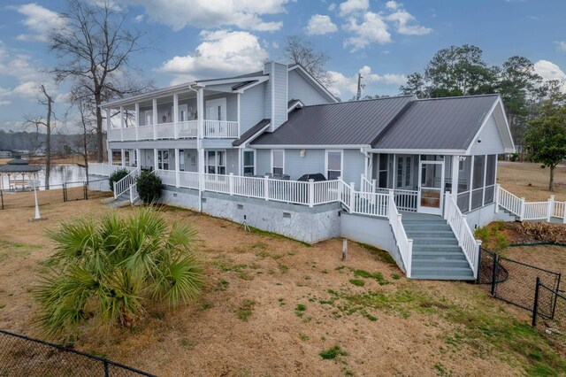 408 Sheffield Ln, Sparta, GA 31087 - back of house with a sunroom, crawl space, metal roof, fence, and stairs