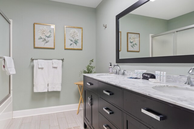 408 Sheffield Ln, Sparta, GA 31087 - full bathroom featuring a sink, baseboards, double vanity, and a shower with door