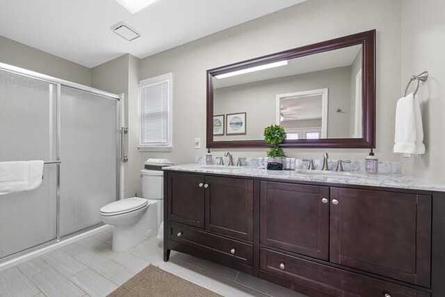 408 Sheffield Ln, Sparta, GA 31087 - full bath with double vanity, a stall shower, a sink, and toilet