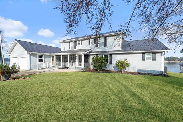 408 Sheffield Ln, Sparta, GA 31087 - rear view of house with a sunroom, an attached garage, metal roof, and a yard