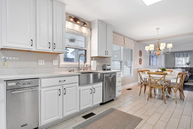 408 Sheffield Ln, Sparta, GA 31087 - kitchen featuring a notable chandelier, light countertops, white cabinetry, stainless steel dishwasher, and a sink