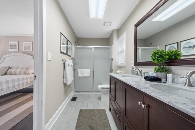 408 Sheffield Ln, Sparta, GA 31087 - ensuite bathroom featuring double vanity, visible vents, a sink, and a stall shower