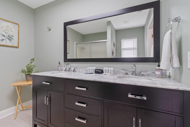 408 Sheffield Ln, Sparta, GA 31087 - full bathroom featuring a shower stall, double vanity, a sink, and baseboards