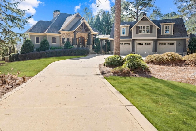 craftsman house with a garage and a front lawn