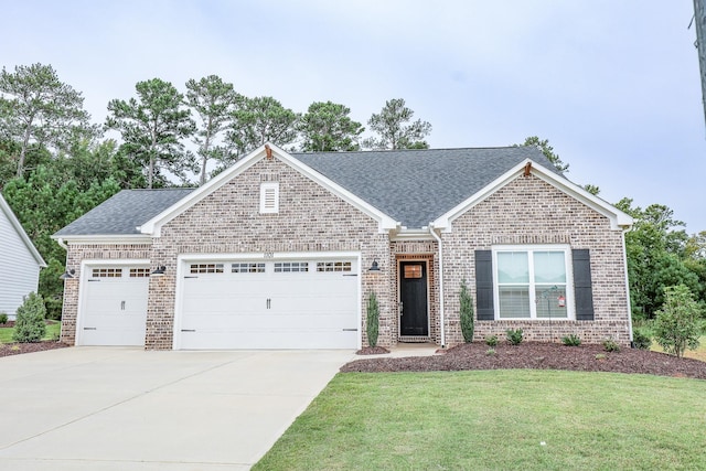 view of front of house featuring a garage and a front lawn