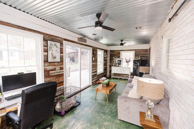 251 Pettigrew Rd, Milledgeville, GA 31061 - interior space featuring finished concrete flooring, brick wall, and a ceiling fan