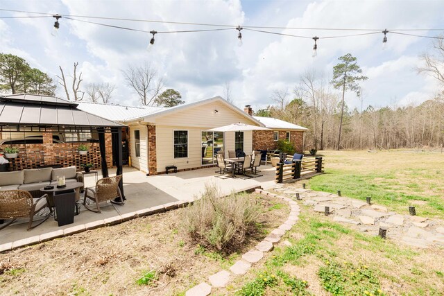 251 Pettigrew Rd, Milledgeville, GA 31061 - rear view of property featuring metal roof, a patio, a gazebo, an outdoor living space, and a yard