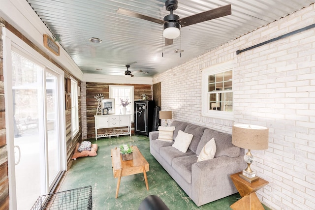 251 Pettigrew Rd, Milledgeville, GA 31061 - living area featuring concrete floors, brick wall, and a ceiling fan