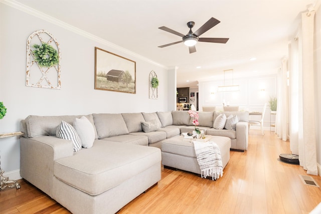 251 Pettigrew Rd, Milledgeville, GA 31061 - living room featuring baseboards, visible vents, light wood-style floors, ceiling fan, and ornamental molding