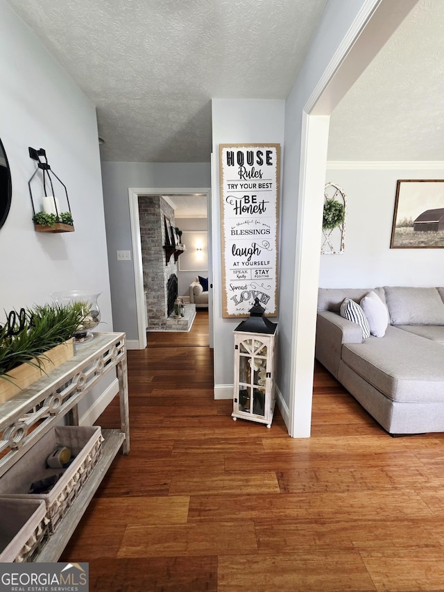 251 Pettigrew Rd, Milledgeville, GA 31061 - hall featuring baseboards, a textured ceiling, and wood finished floors