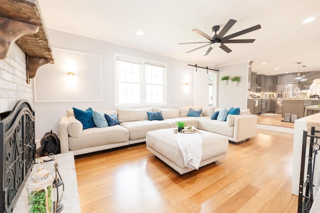 251 Pettigrew Rd, Milledgeville, GA 31061 - living room with crown molding, a barn door, light wood-style flooring, ceiling fan, and recessed lighting