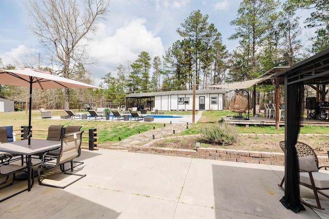 251 Pettigrew Rd, Milledgeville, GA 31061 - view of patio / terrace featuring fence, a deck, an outdoor structure, and a fenced in pool
