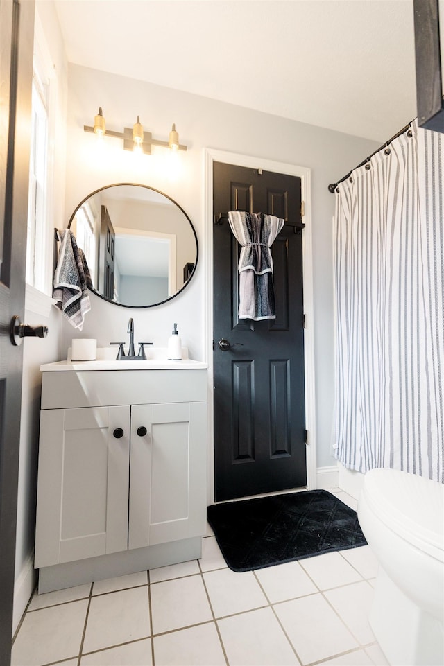 251 Pettigrew Rd, Milledgeville, GA 31061 - bathroom featuring a shower with curtain, tile patterned flooring, vanity, toilet, and baseboards