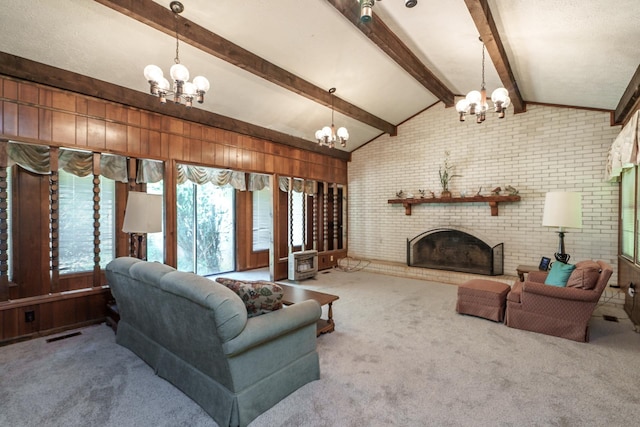 carpeted living room with brick wall, a brick fireplace, vaulted ceiling with beams, and a chandelier