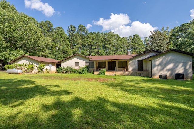 view of front of house featuring central AC unit and a front lawn