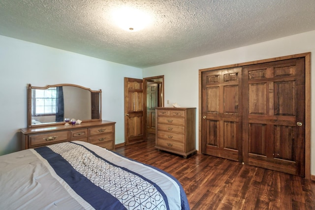 bedroom with dark wood-type flooring and a textured ceiling