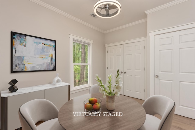 1101 Maple Ridge Way, Greensboro, GA 30642 - dining area with a ceiling fan, visible vents, ornamental molding, and light wood-style floors