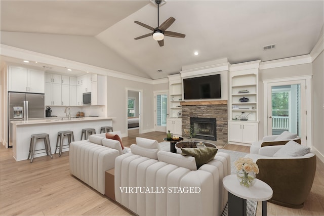 1101 Maple Ridge Way, Greensboro, GA 30642 - living room featuring a ceiling fan, a stone fireplace, visible vents, baseboards, and light wood-style floors