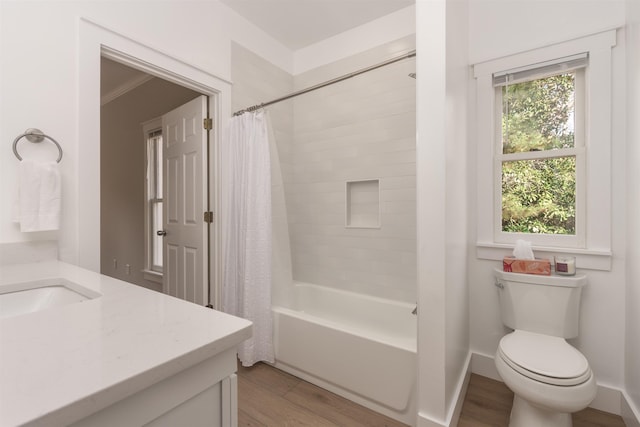 full bathroom featuring hardwood / wood-style flooring, vanity, toilet, and shower / tub combo